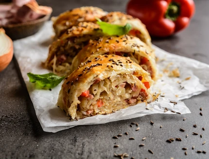 Savory strudel with sour cabbage, bacon and onion